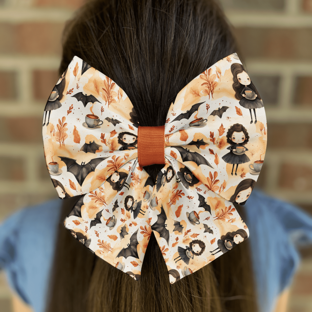 Autumn-themed hair bow with bats and witches.