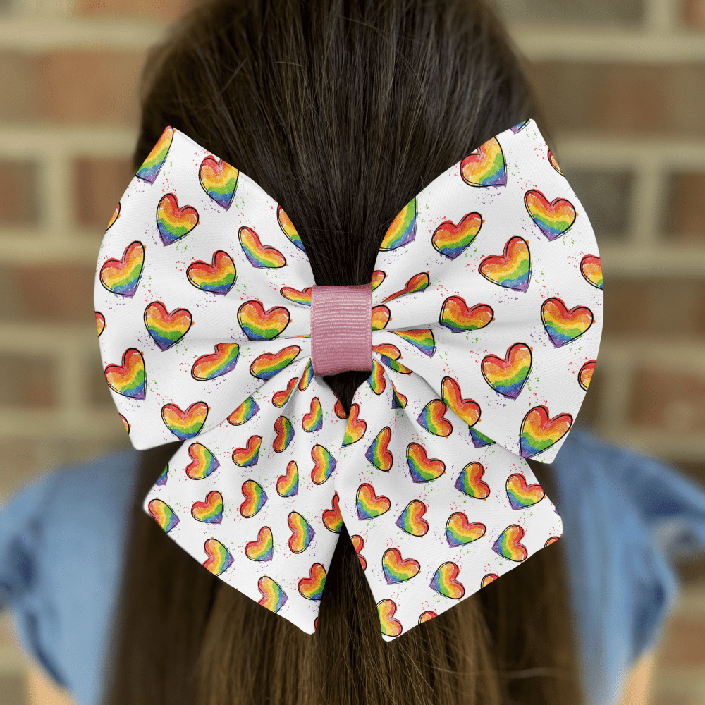 Rainbow heart bow on brown hair