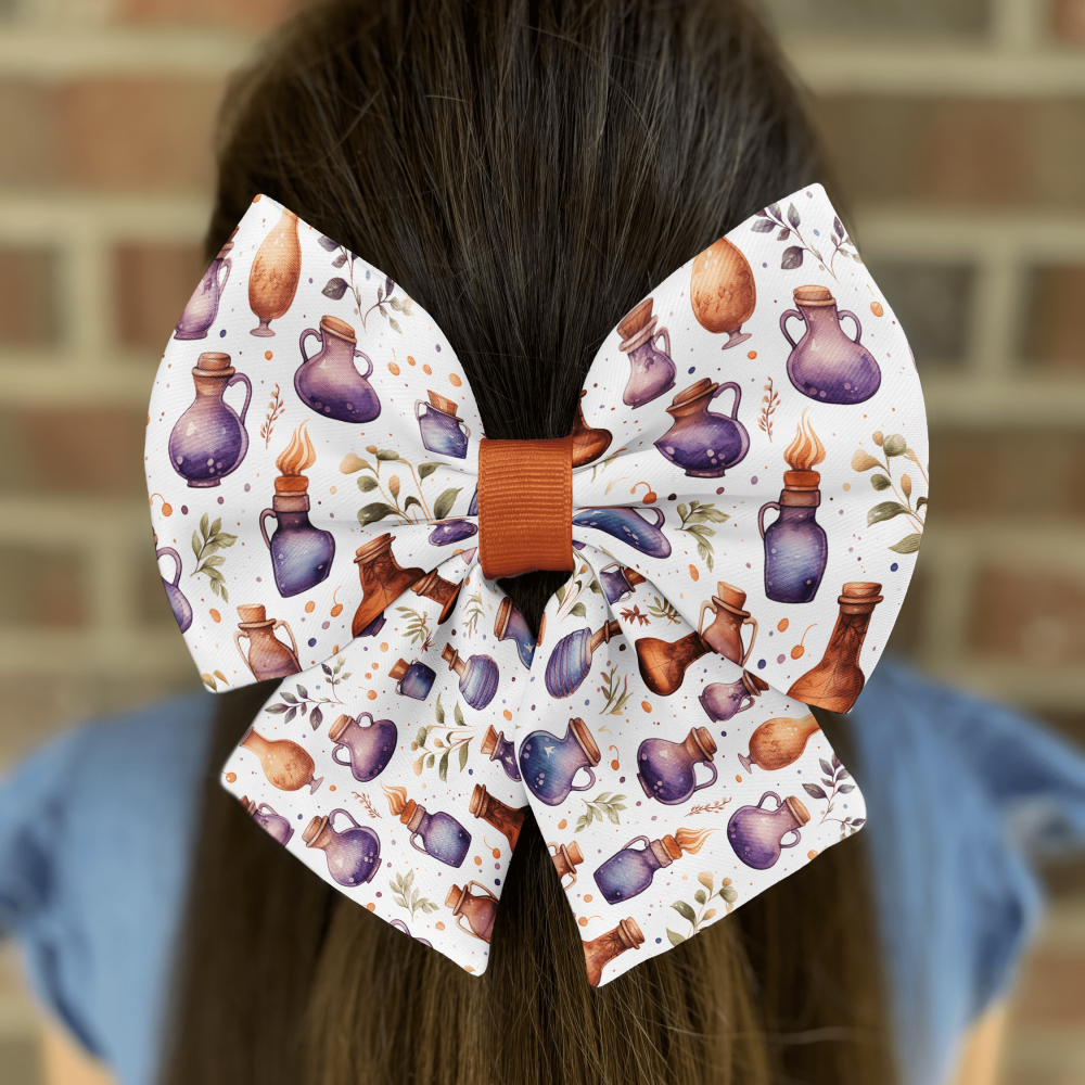 Colorful bow with potion bottles print on hair.