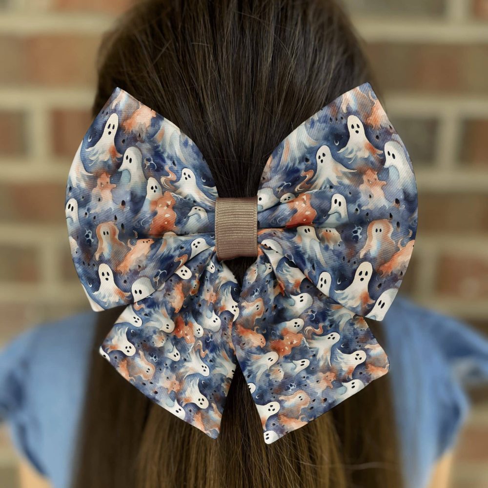 Girl wearing hair bow with ghost pattern