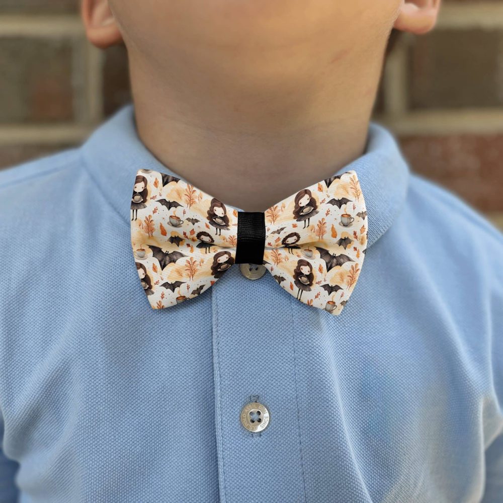 Child in blue shirt with Halloween bow tie.