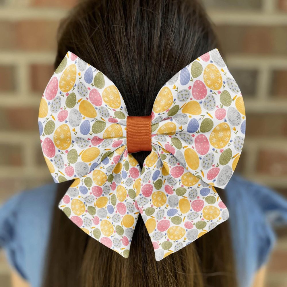 Colorful Easter bow on girl's brown hair.