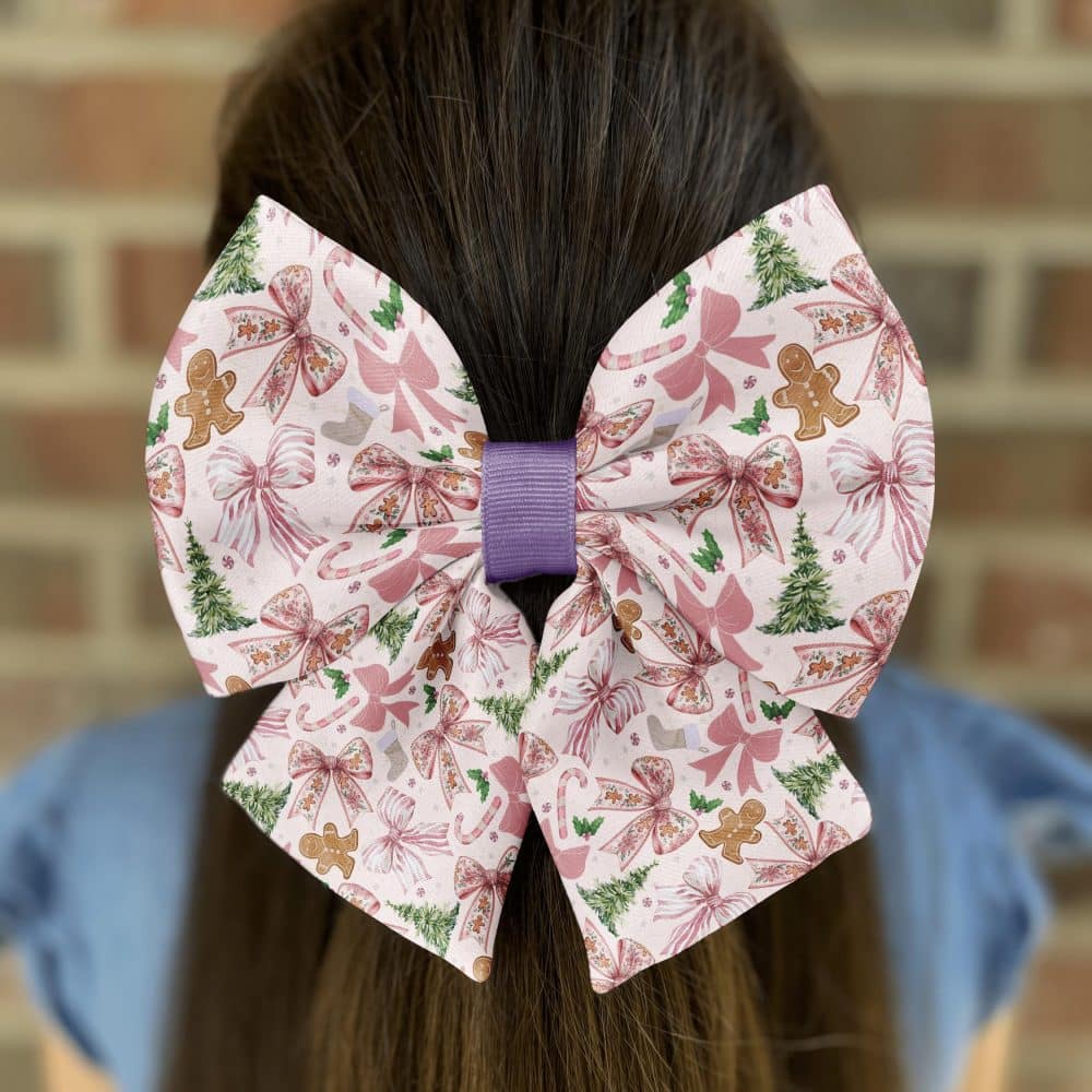 Festive bow with gingerbread and candy patterns in hair.