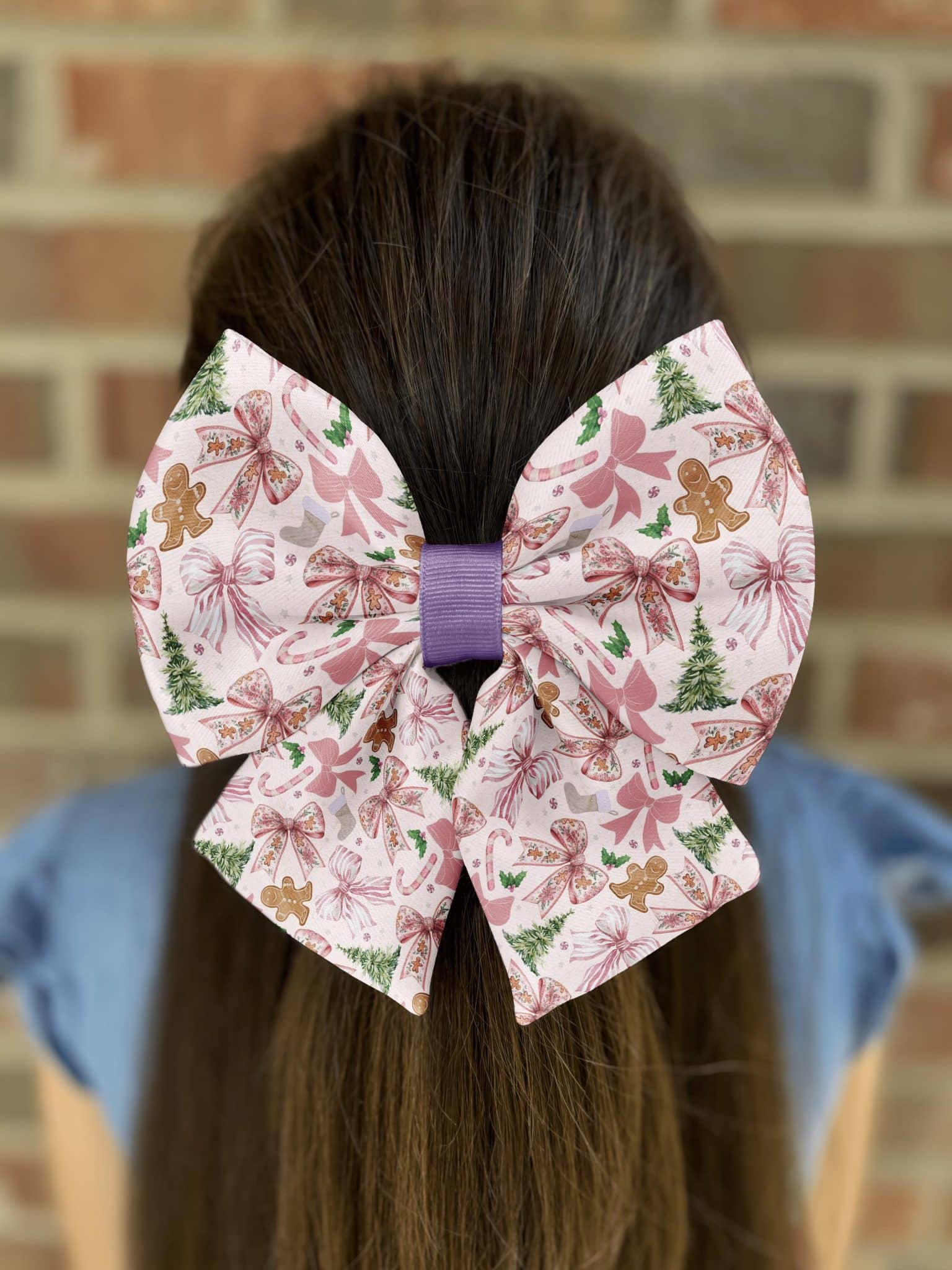 Festive bow with gingerbread and candy patterns in hair.