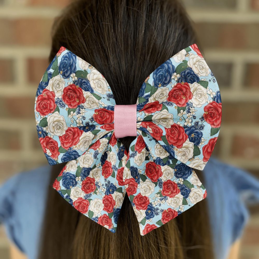 Hair with floral-patterned bow against brick wall.