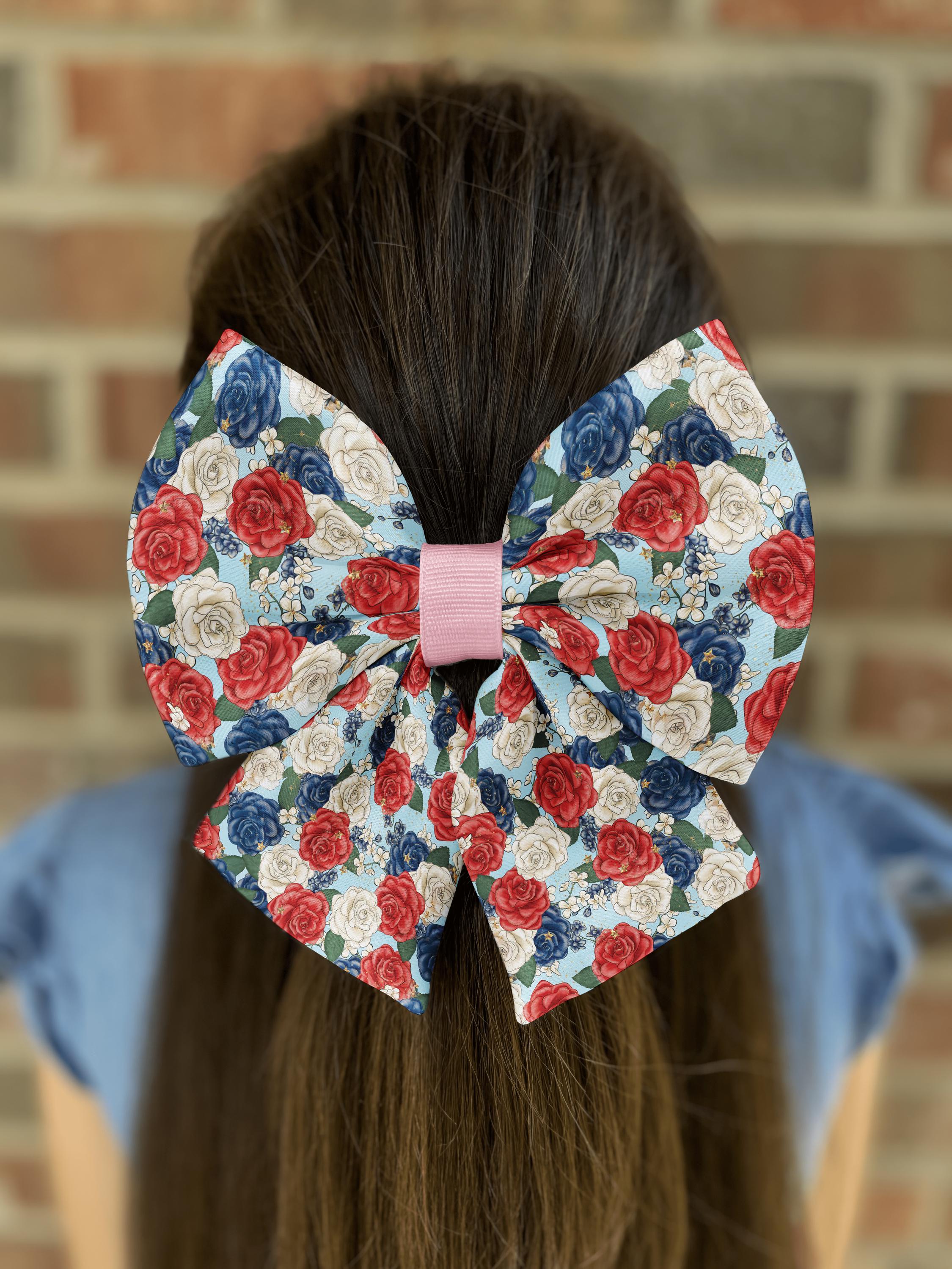 Hair with floral-patterned bow against brick wall.