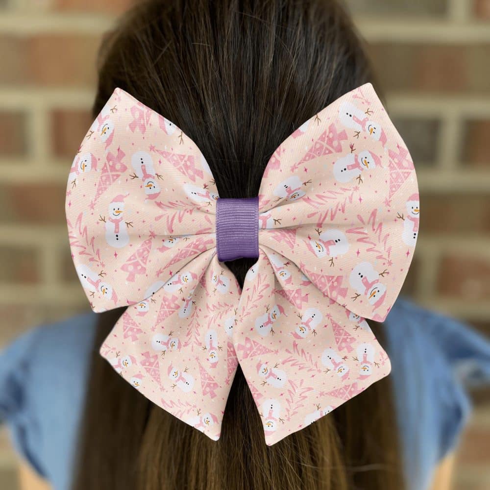 Girl wearing bow with snowman print