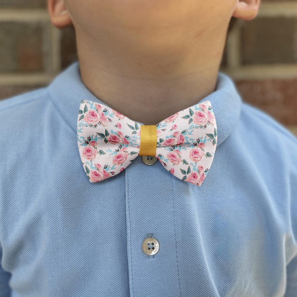 Child in blue shirt with floral bow tie