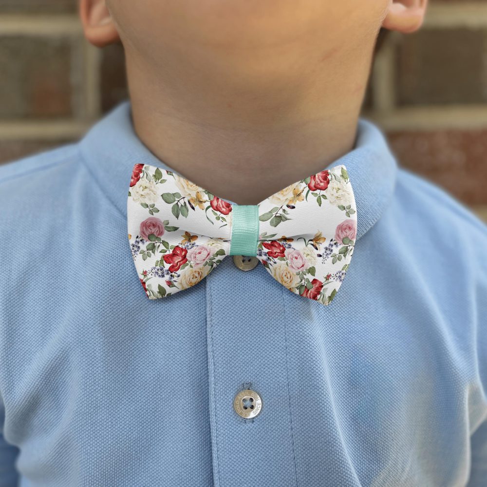 Child wearing floral bow tie and blue shirt