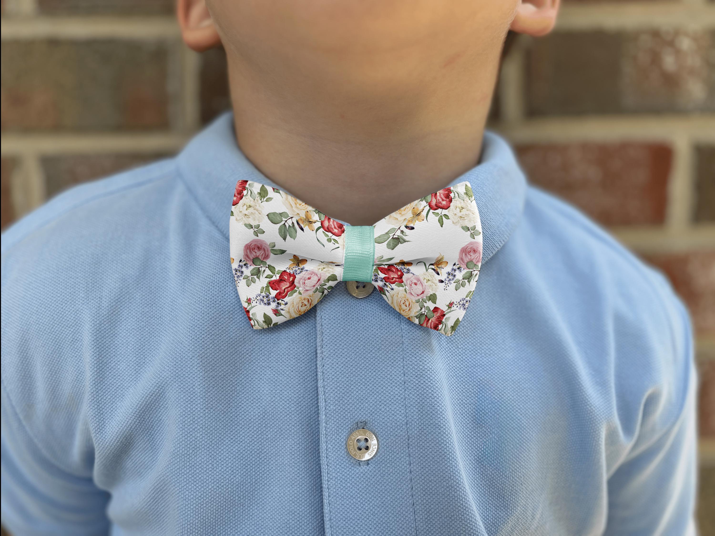 Child wearing floral bow tie and blue shirt