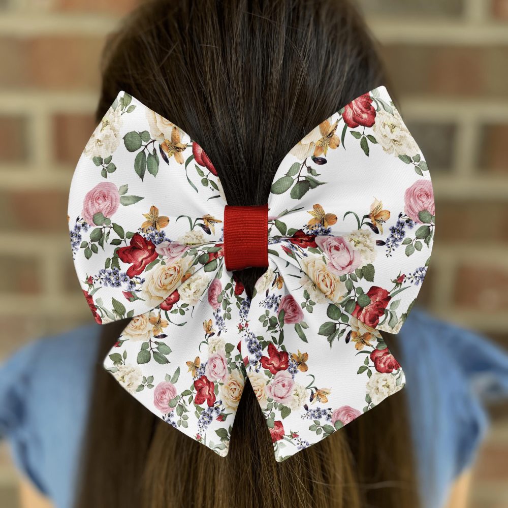 Floral bow in brown hair against brick wall.