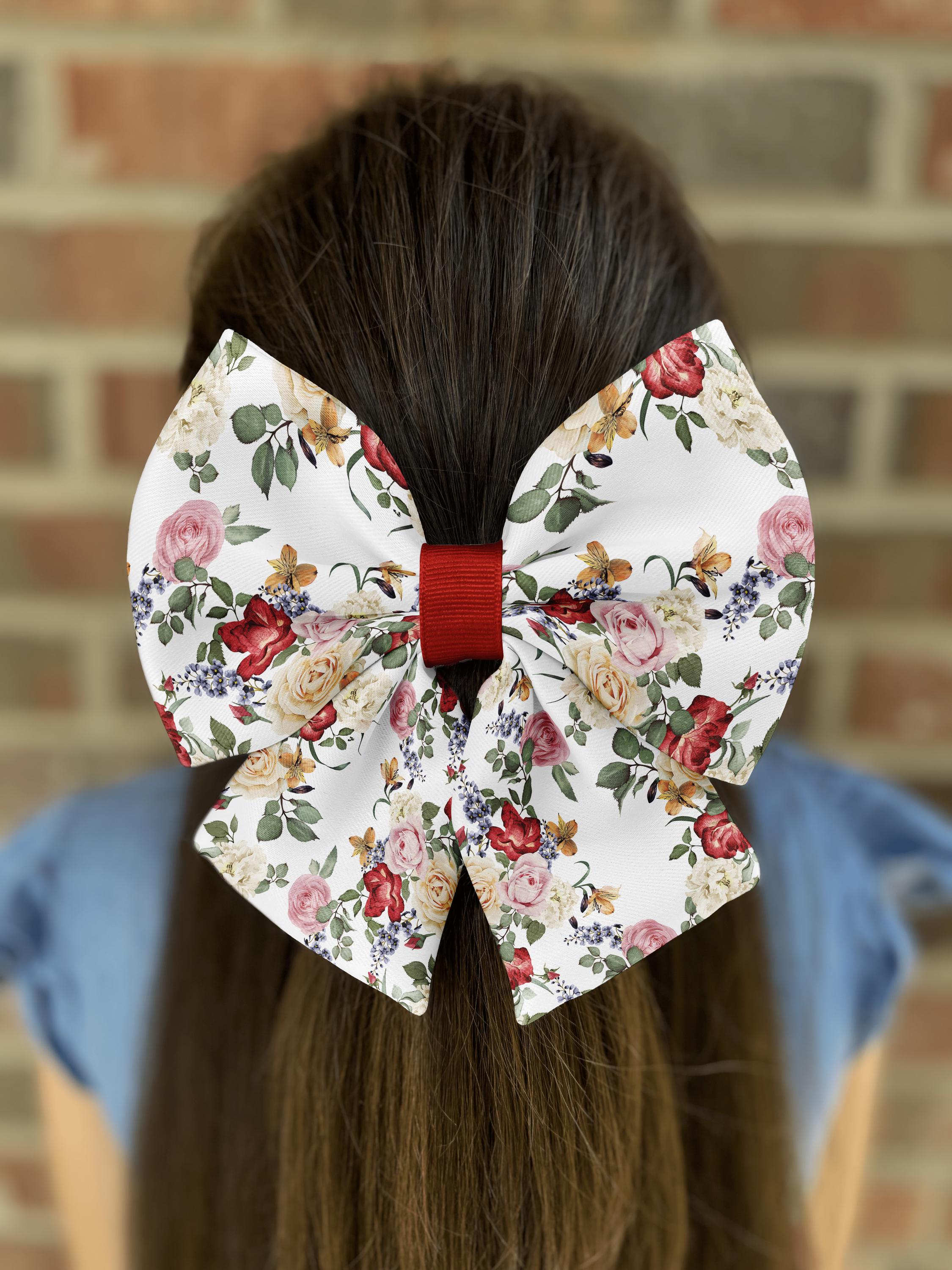 Floral bow in brown hair against brick wall.